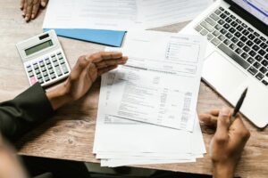 Bedrijfsmakelaar bespreekt overname-dossier met ondernemer aan vergadertafel