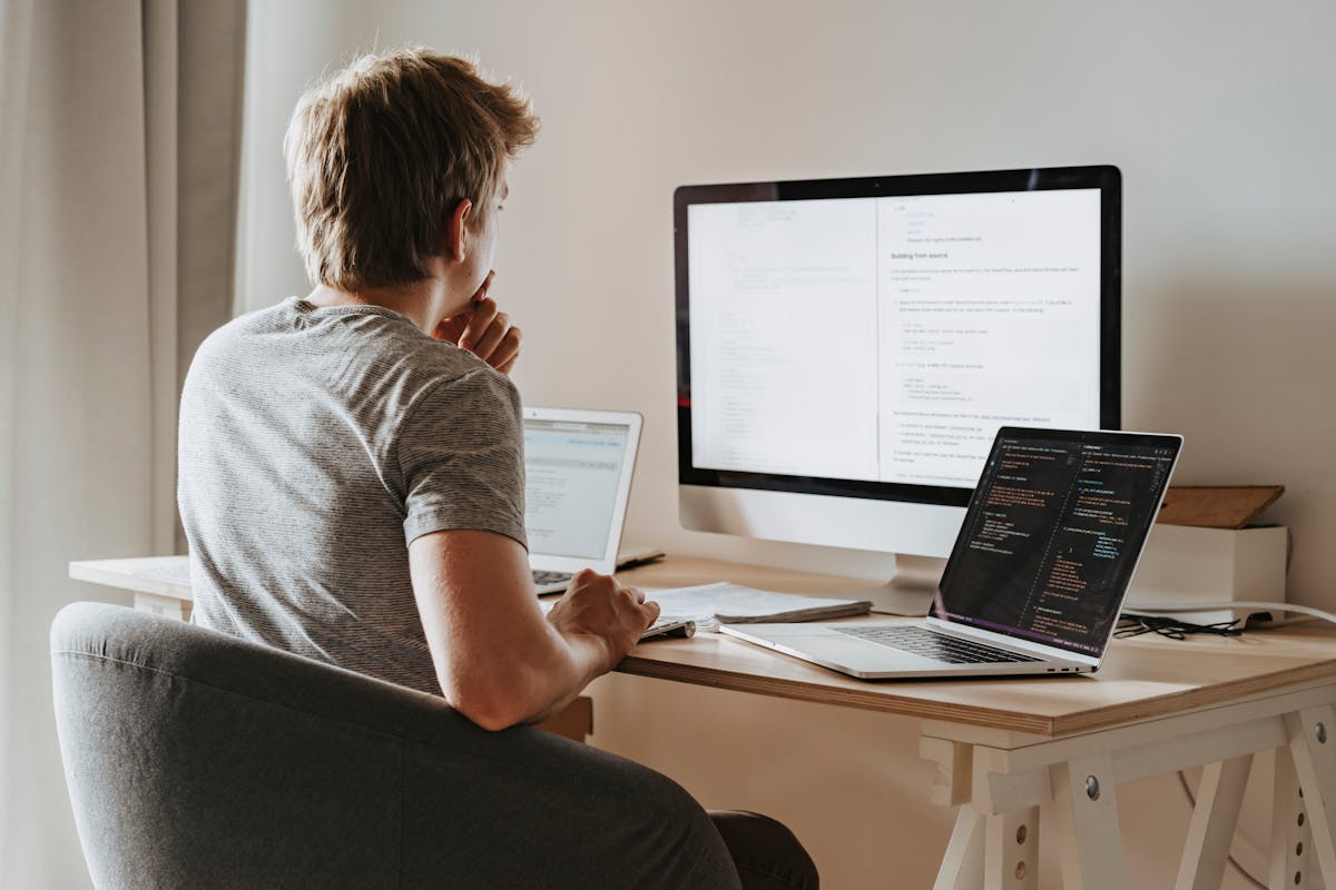 Freelance IT-consultant aan laptop met code en cloud-dashboard